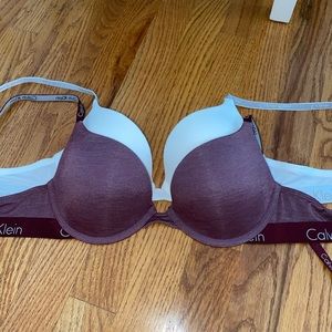 selling two Calvin Klein bras. white and burgundy